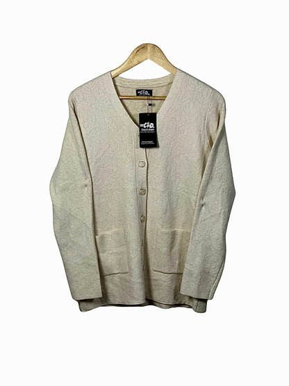 Cozy&Drape cream wool cardigan sweater with long sleeves, front button closure, and two patch pockets on a hanger.