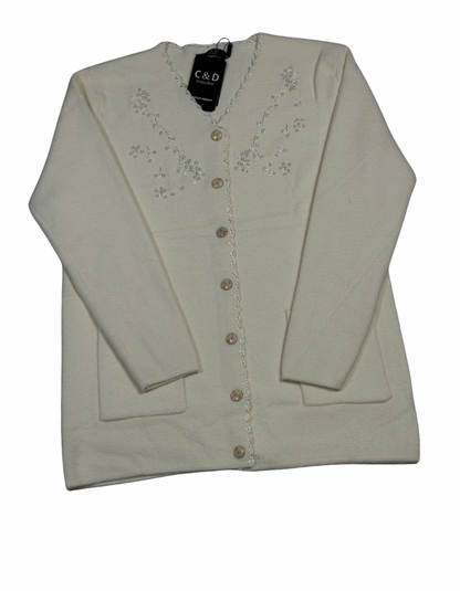 Cozy&Drape cream wool cardigan with long sleeves, front buttons, pockets, and delicate floral embroidery detail