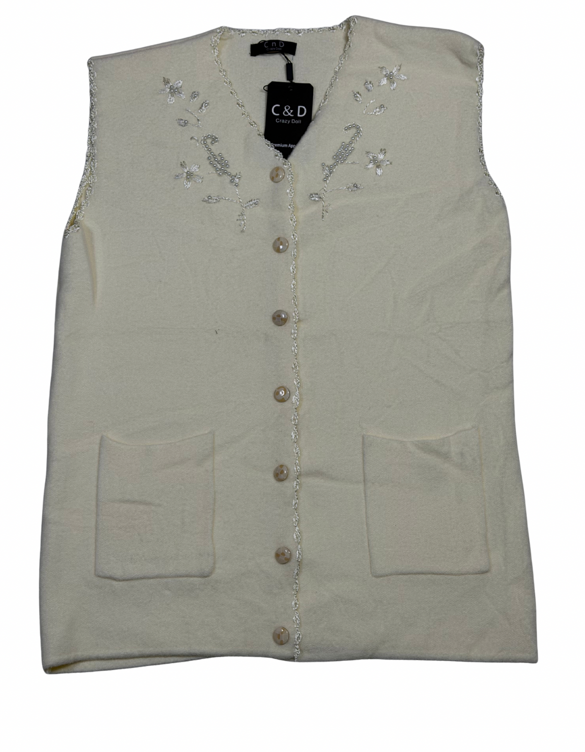 Cozy&Drape sleeveless wool cardigan in cream with floral embroidery, front buttons, and two patch pockets.