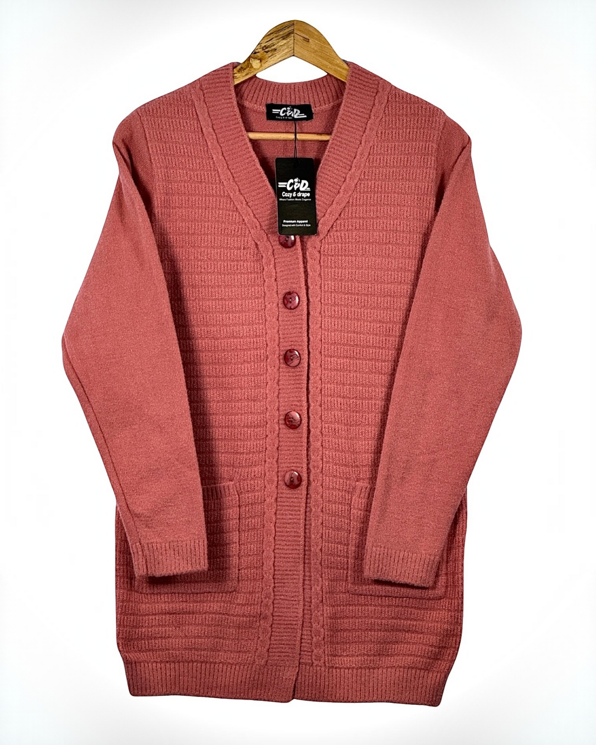 Cozy&Drape long button-down cardigan sweater in dusty rose with ribbed texture and front pockets on a wooden hanger