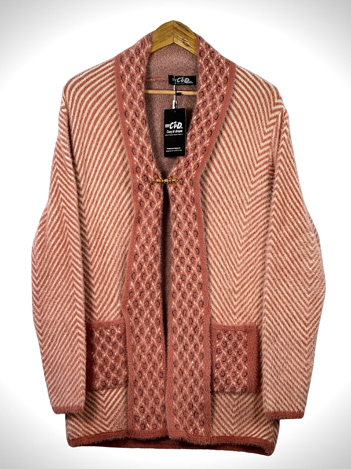 Cozy&Drape open front sweater in dusty pink with chevron pattern, textured trim, and two front pockets on a hanger.