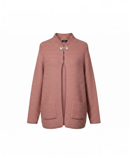 Cozy&Drape dusty rose knit cardigan with a mock neck, long sleeves, front pockets, and a decorative brooch closure.