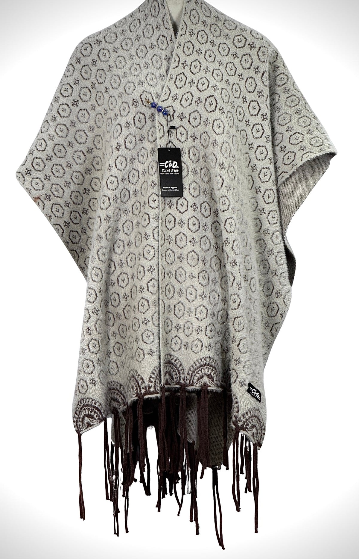 Cozy&Drape grey patterned cape shawl with brown geometric print and fringe hem for winter warmth and style.