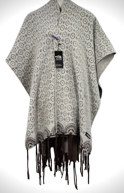 Cozy&Drape grey patterned cape shawl with brown geometric print and fringe hem for winter warmth and style.