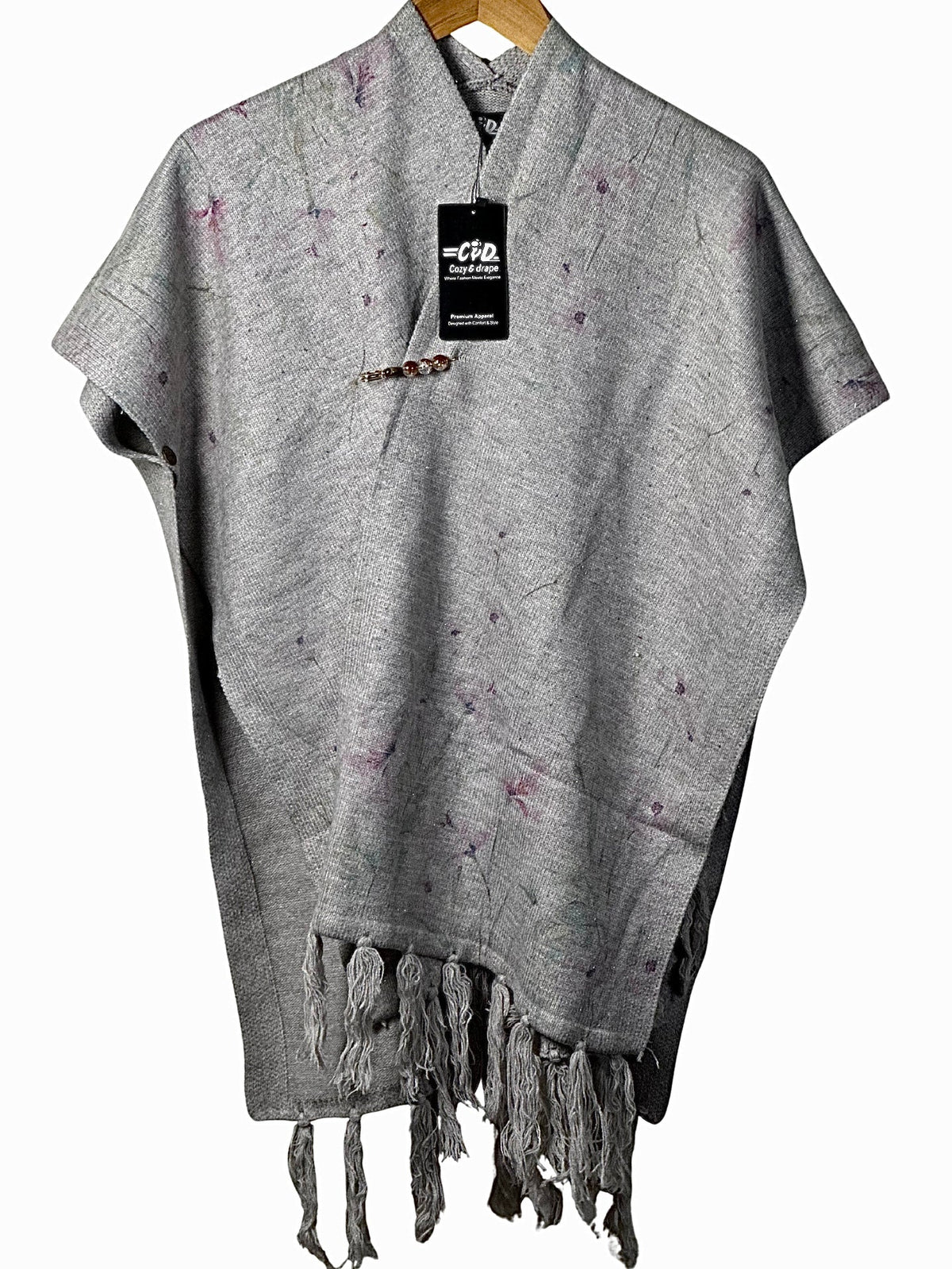 Cozy&Drape grey winter cape shawl with subtle purple floral accents, featuring a decorative brooch and fringe hem.
