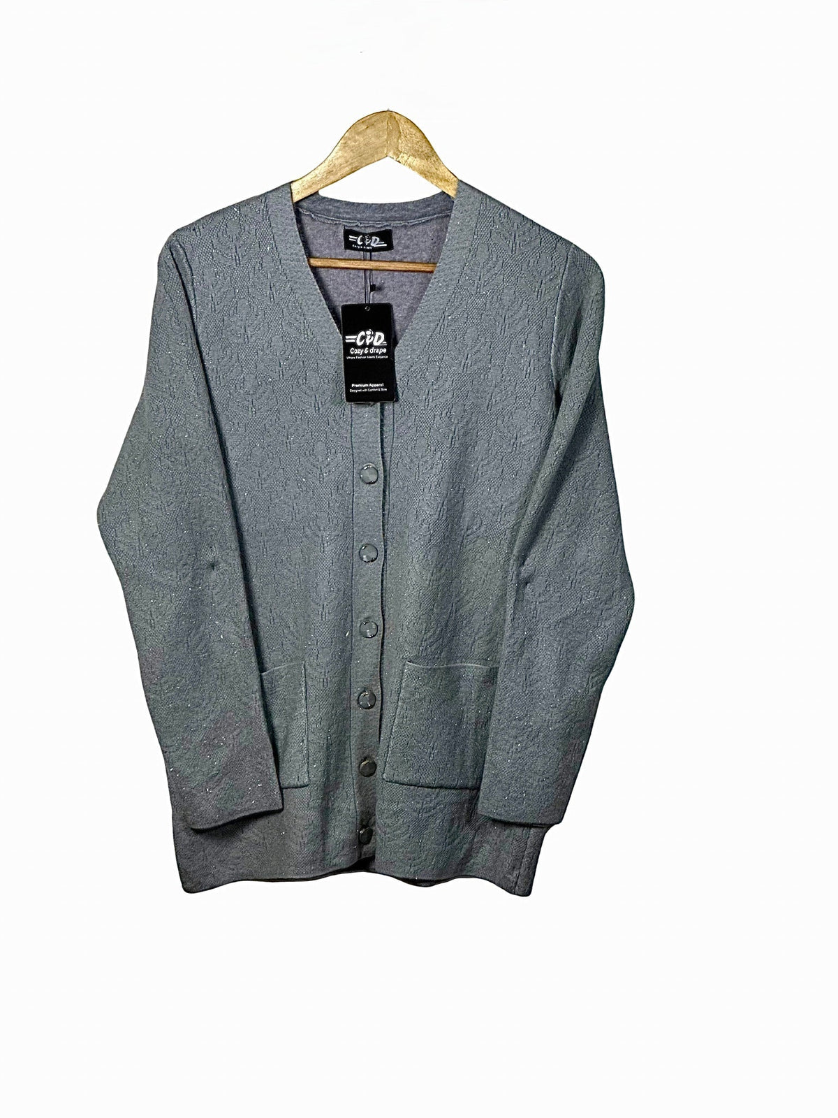 Cozy&Drape grey wool cardigan sweater with full sleeves, button-front closure, and two front pockets on a hanger.