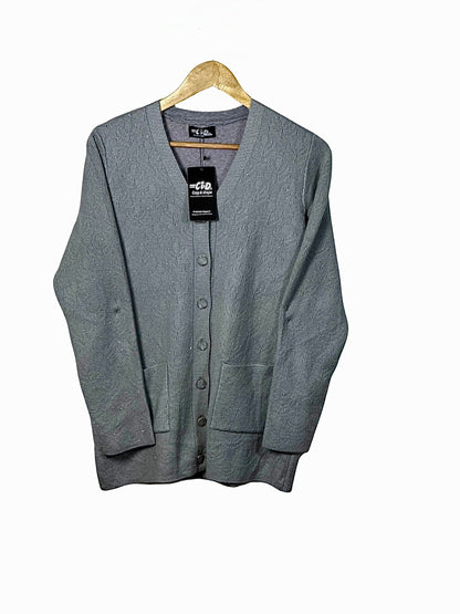 Cozy&Drape grey wool cardigan sweater with full sleeves, button-front closure, and two front pockets on a hanger.