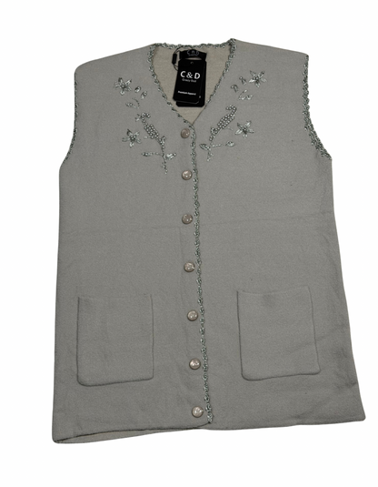 Cozy&Drape sleeveless wool cardigan in grey with floral beadwork, front buttons, and two patch pockets.