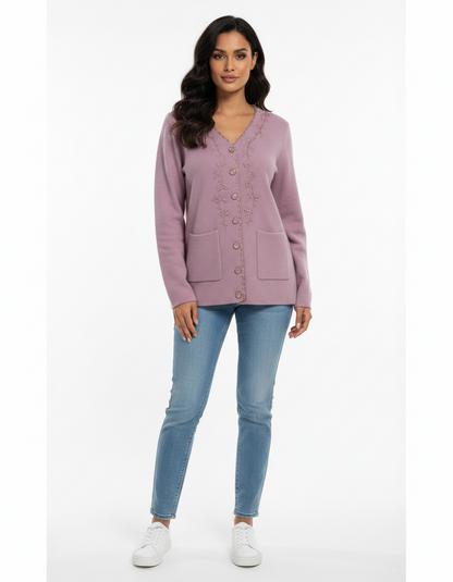 Cozy&Drape mauve V-neck knit cardigan with floral embroidery, button front, and pockets worn with blue jeans.