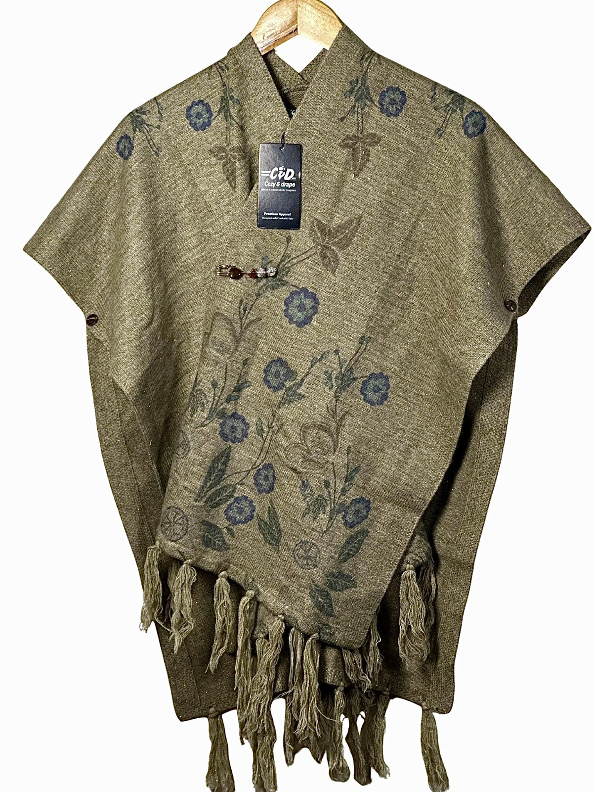 Cozy&Drape olive green winter cape shawl with blue floral print, button closure, and decorative fringe hem.
