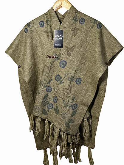 Cozy&Drape olive green winter cape shawl with blue floral print, button closure, and decorative fringe hem.