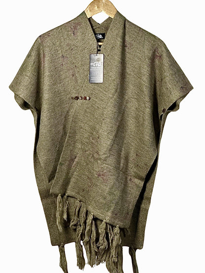 Cozy&Drape olive green winter cape shawl with fringe hem and decorative button detail on a wooden hanger
