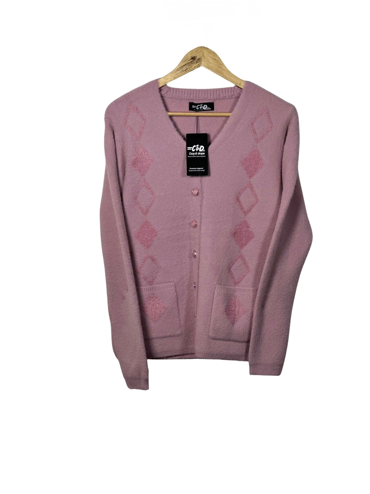 Cozy&Drape pink long-sleeve cardigan sweater with diamond pattern, front buttons, and two pockets on a wooden hanger.