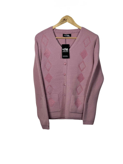 Cozy&Drape pink long-sleeve cardigan sweater with diamond pattern, front buttons, and two pockets on a wooden hanger.