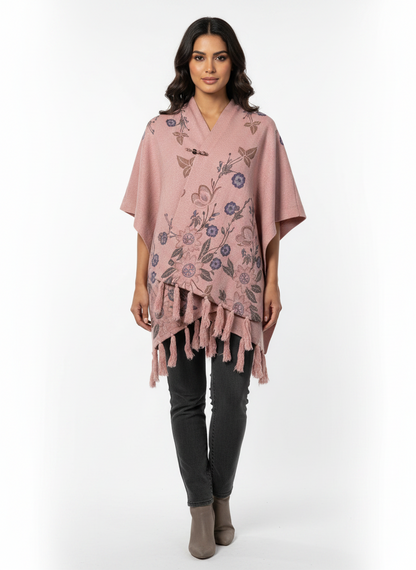 Cozy&Drape pink floral knit poncho wrap with front toggle closure and fringe hem worn by a model