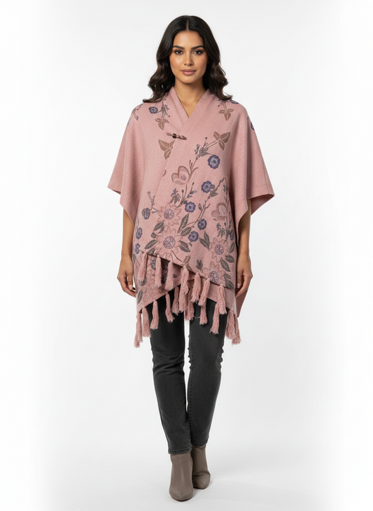 Cozy&Drape pink floral knit poncho wrap with front toggle closure and fringe hem worn by a model
