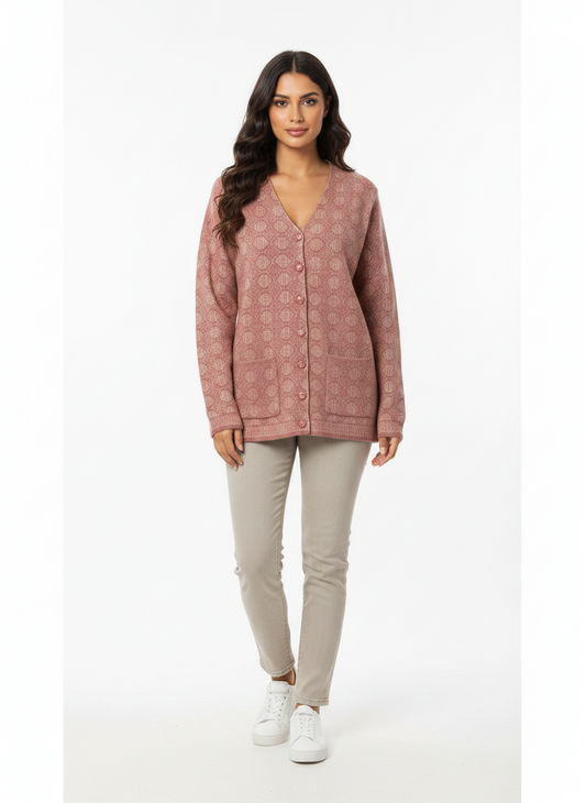 Model wearing a Cozy&Drape pink V-neck button-up cardigan with a geometric pattern and two front pockets