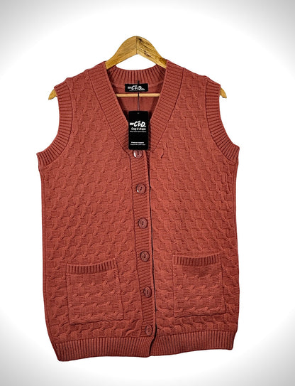 Cozy&Drape sleeveless cardigan sweater in terracotta with cable knit texture, button front, and two patch pockets.
