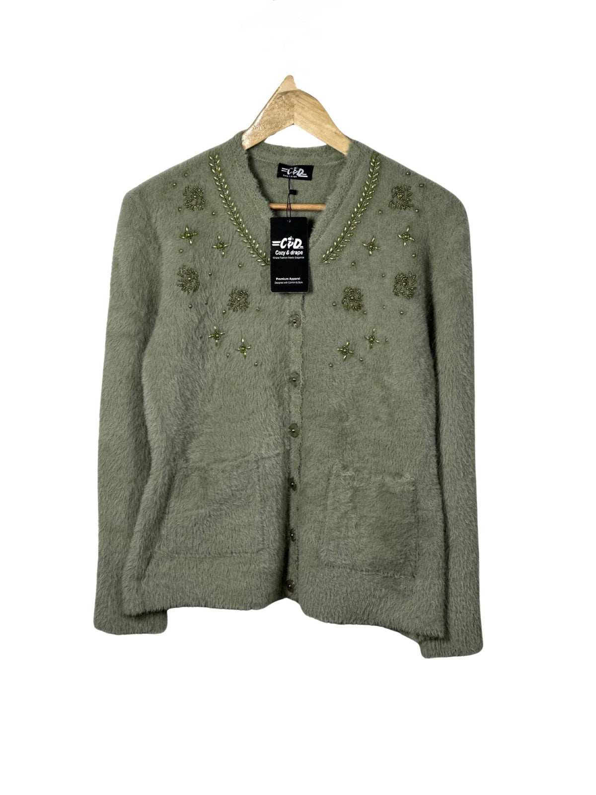 Cozy&Drape sage green fuzzy cardigan sweater with beaded floral embroidery and front pockets on a wooden hanger