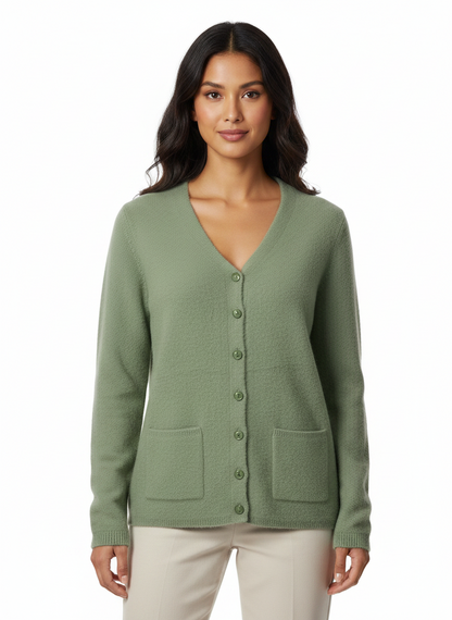 Model wearing a sage green Cozy&Drape button-up knit cardigan with a V-neckline and two front pockets.