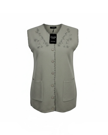 Cozy&Drape sage green sleeveless knit cardigan with V-neckline, floral beadwork, button front, and patch pockets.
