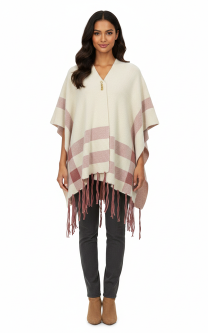 Cozy&Drape cream and dusty rose striped cape shawl with fringe hem worn by a woman against a white background
