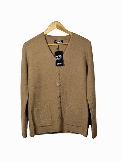 Cozy&Drape tan button-up cardigan sweater with long sleeves and front pockets on a wooden hanger