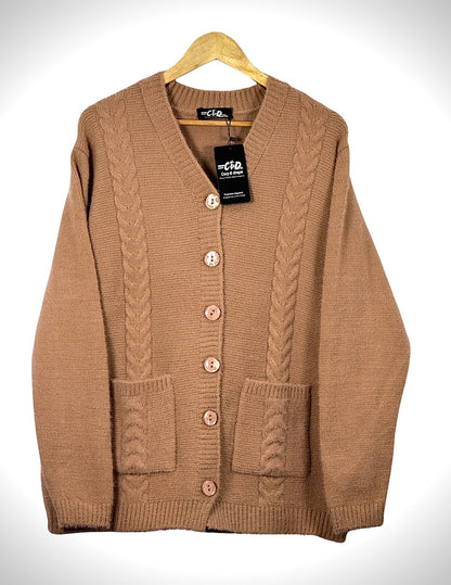 Cozy&Drape tan cable knit cardigan sweater with full sleeves, front buttons, and two patch pockets on a hanger.