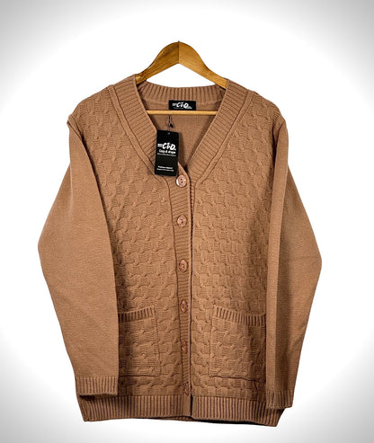 Cozy&Drape tan cable knit cardigan sweater with long sleeves, button front closure, and two front pockets on a hanger