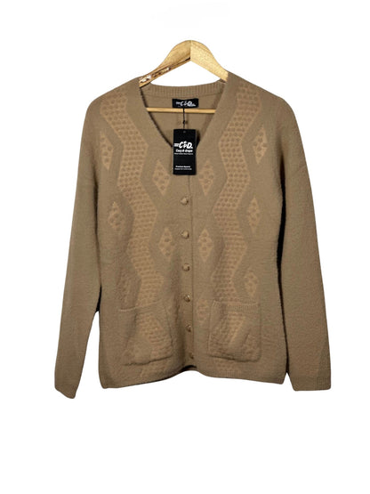 Cozy&Drape tan button-up cardigan sweater with textured diamond pattern and front pockets on a wooden hanger