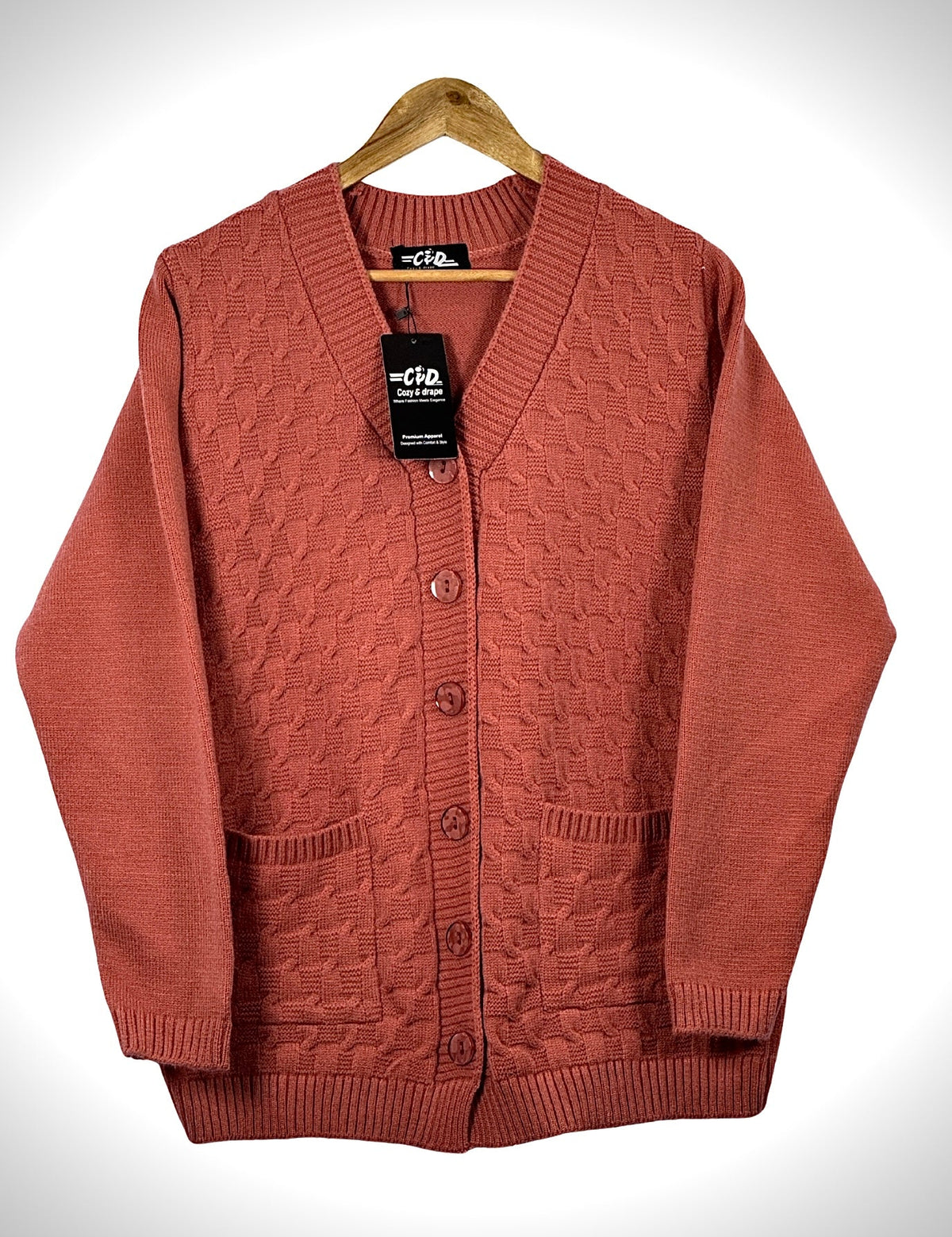 Cozy&Drape terracotta cable knit cardigan sweater with long sleeves, front buttons, and two patch pockets.