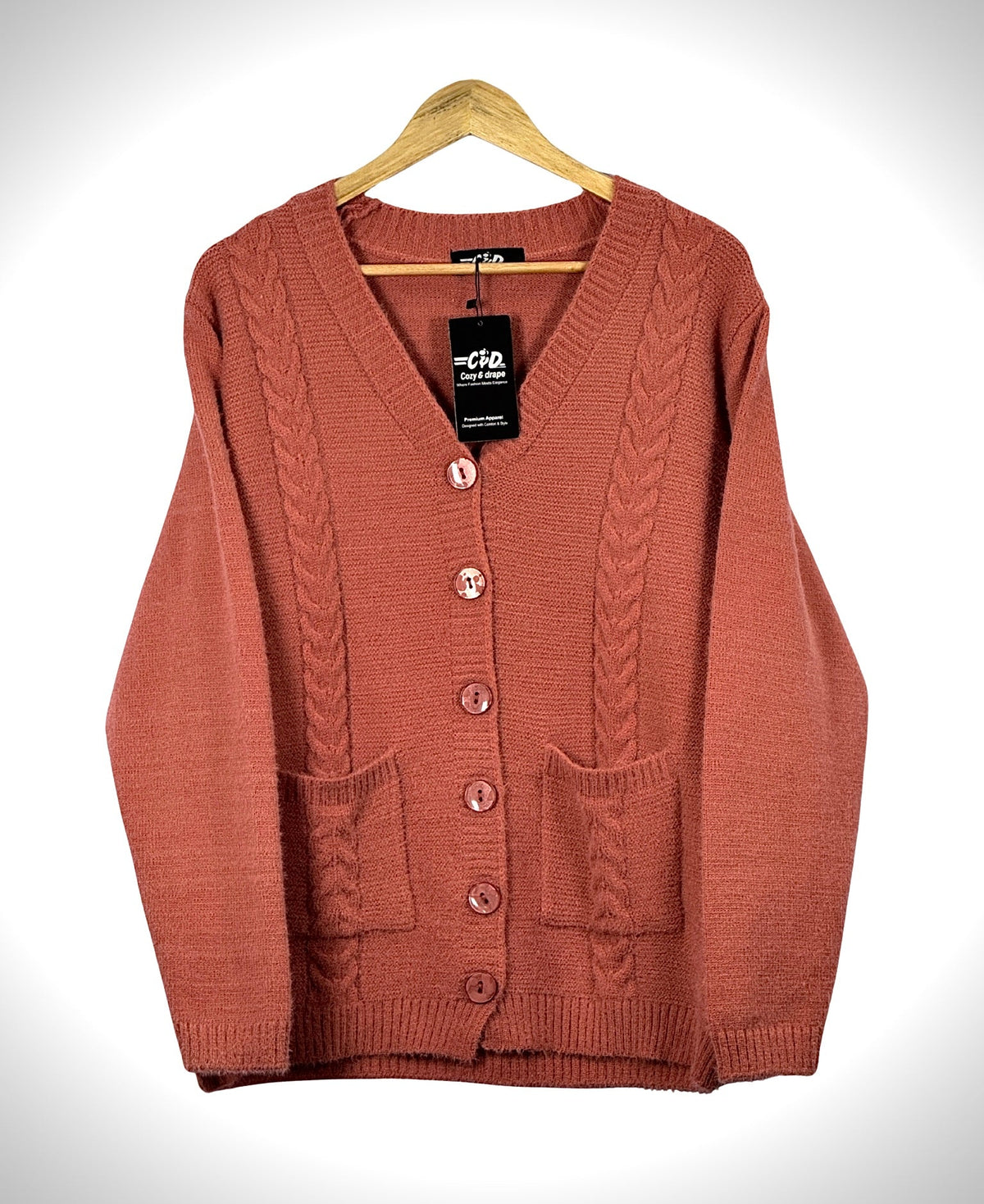 Cozy&Drape terracotta cable knit cardigan sweater with a V-neck, front buttons, and two patch pockets.