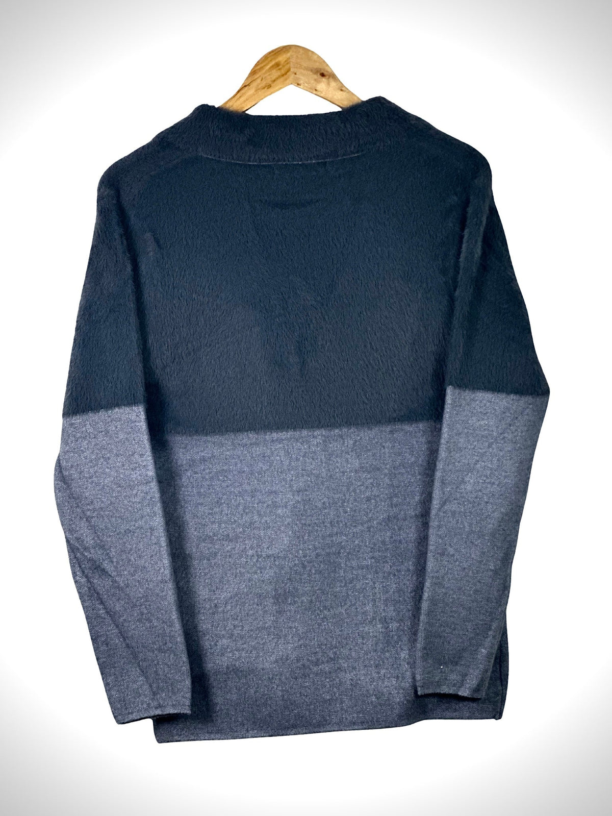 Cozy&Drape two-tone color-blocked knit sweater coat in navy and grey, back view on a wooden hanger.